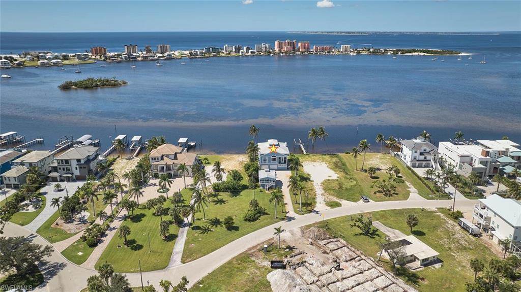 Aerial view of property and surrounding area with nearby suburban area