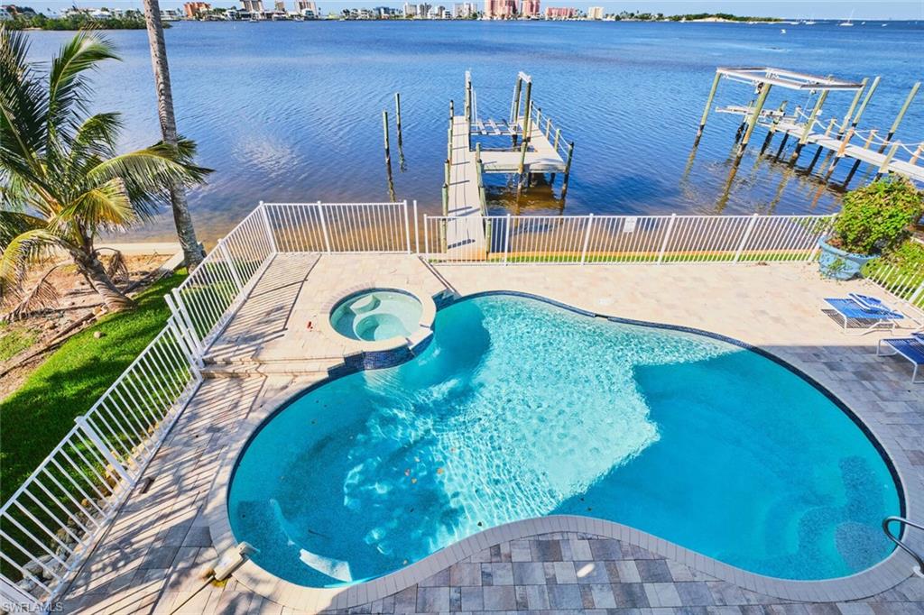 Main living area -  View of swimming pool with a water view, a pool with connected hot tub, a patio, and a view of city