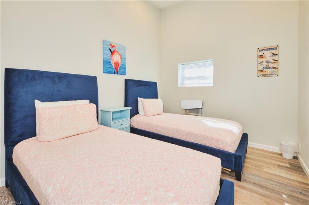 Bedroom 2 of apartment on first levelwith light wood finished floors and a towering ceiling
