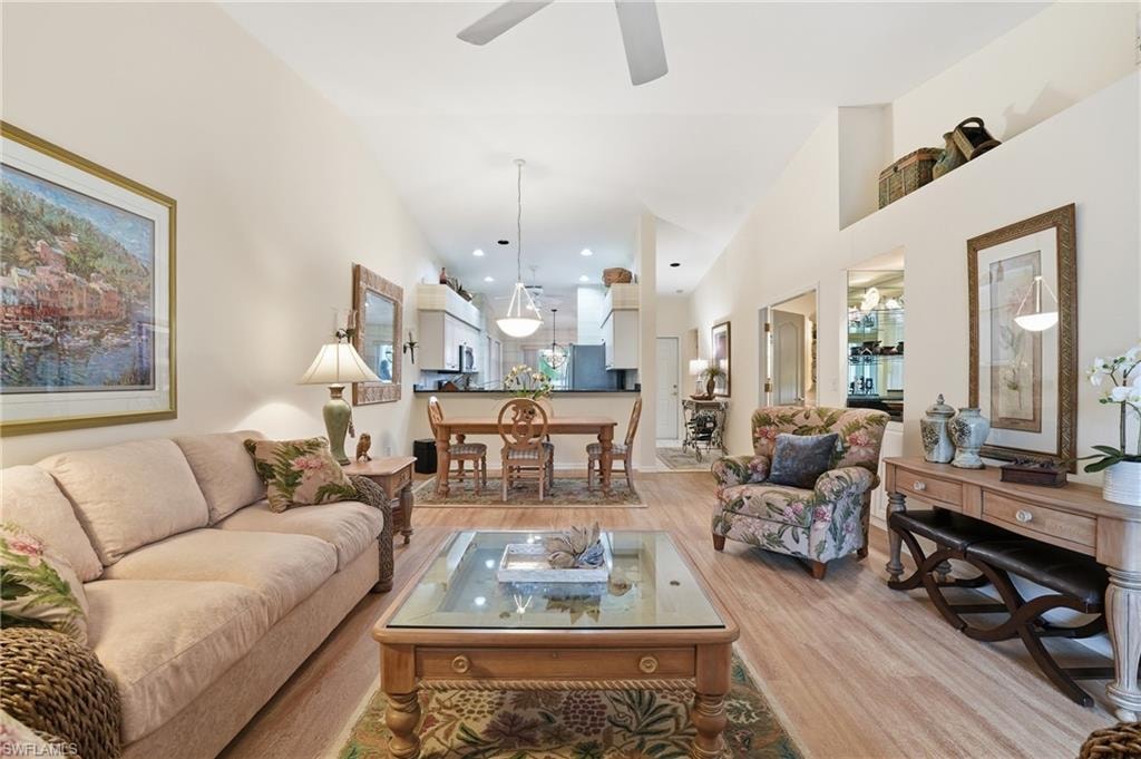 Living room featuring light wood finished floors and high vaulted ceiling