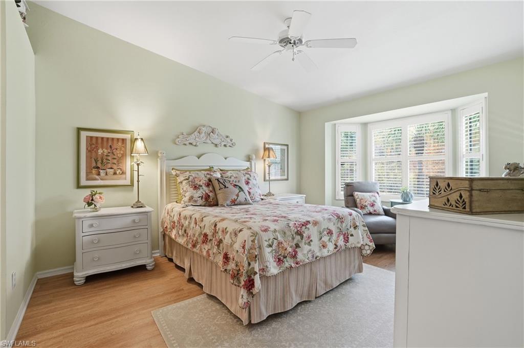 Bedroom with light wood finished floors and a ceiling fan