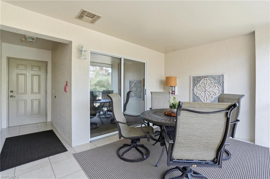 Outdoor room featuring a textured wall and tile patterned floors