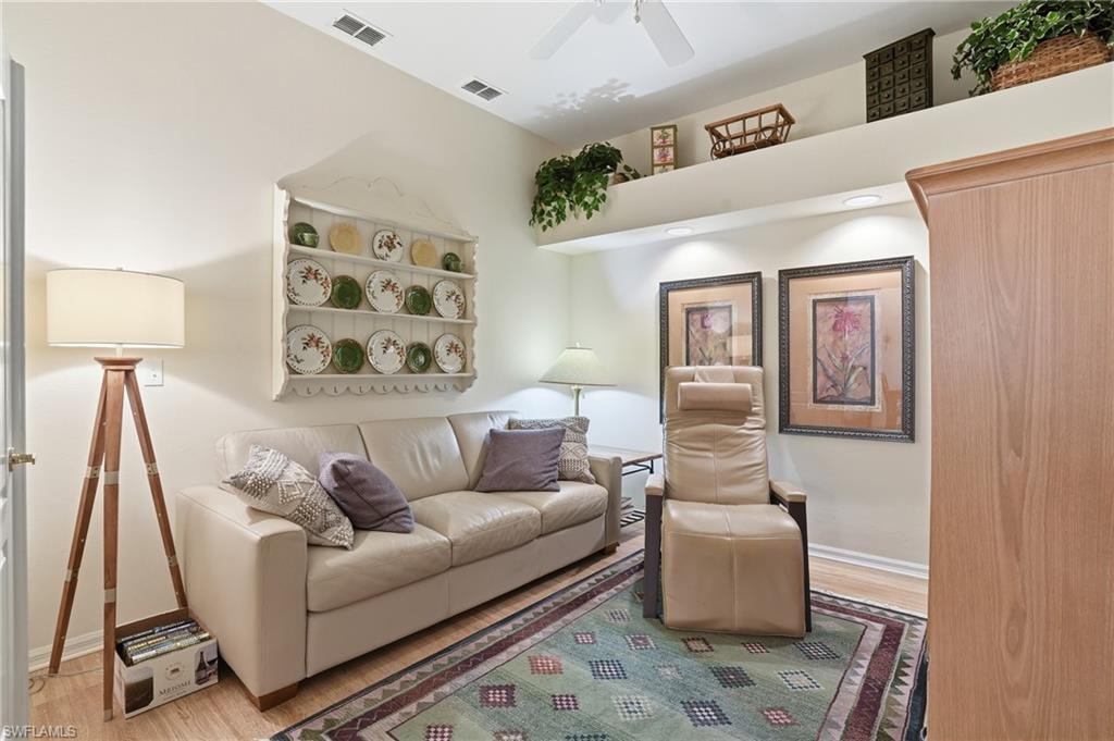 Living area with wood finished floors and a ceiling fan