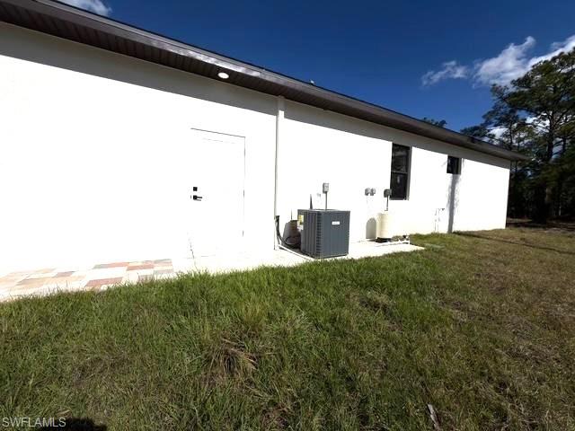 Back of property with a yard and a patio area
