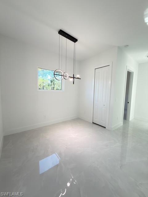 Unfurnished dining area featuring baseboards