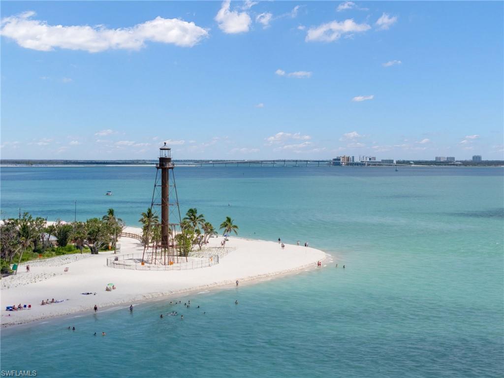 Water view featuring nearby beach and a pier