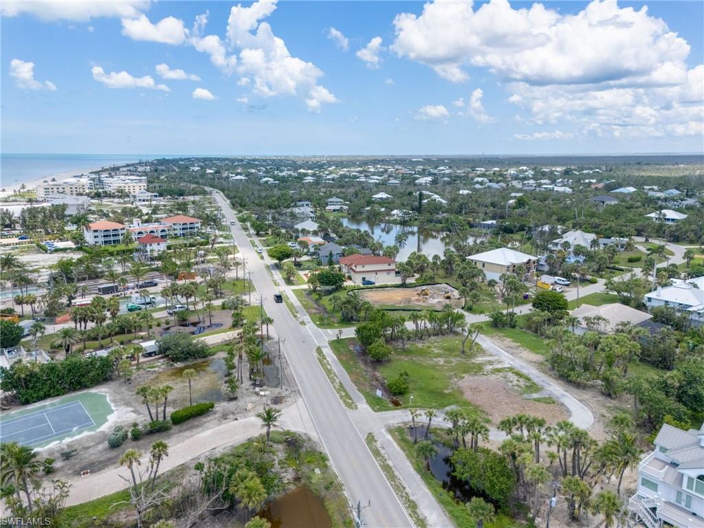 Aerial overview of property's location with a nearby body of water and nearby suburban area