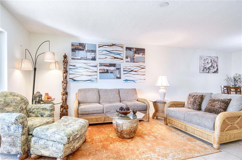 Living area with a textured ceiling and tile patterned flooring