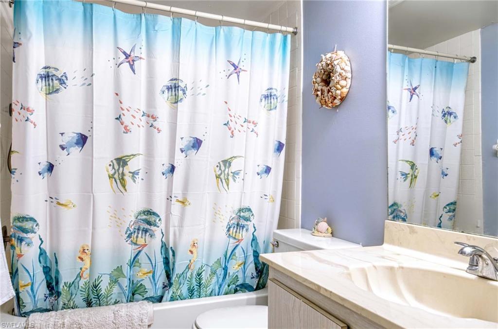 Full bathroom featuring vanity and shower / bath combo with shower curtain
