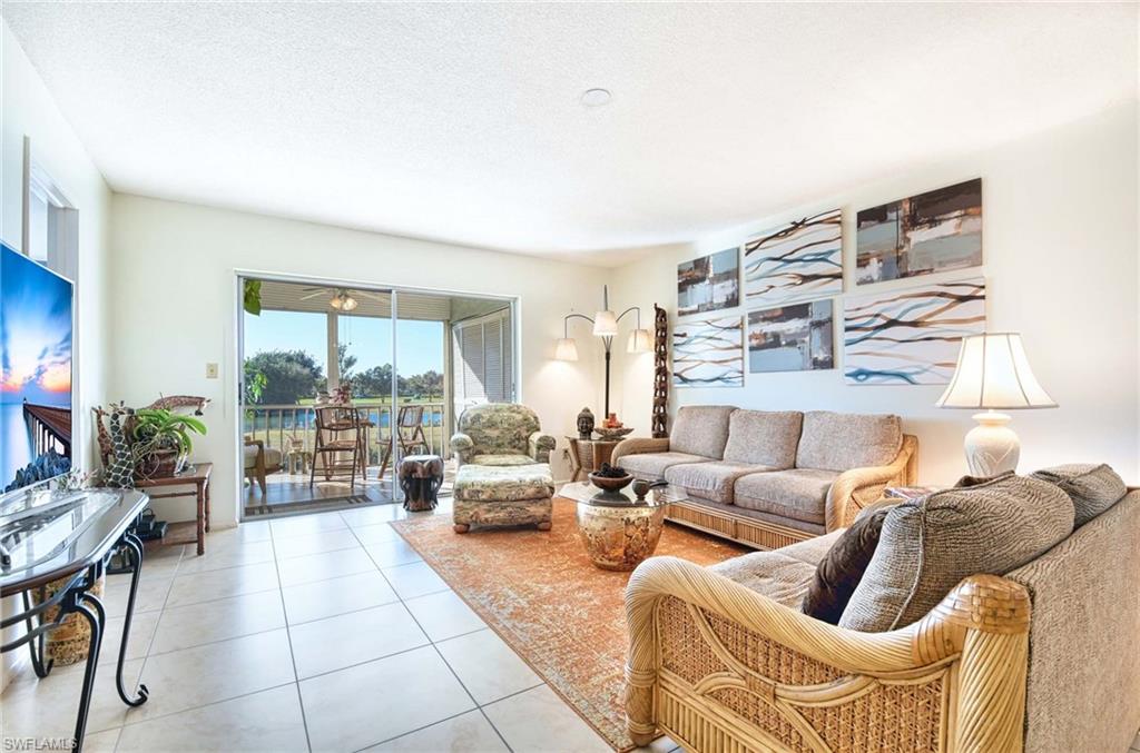 Tiled living area featuring a textured ceiling