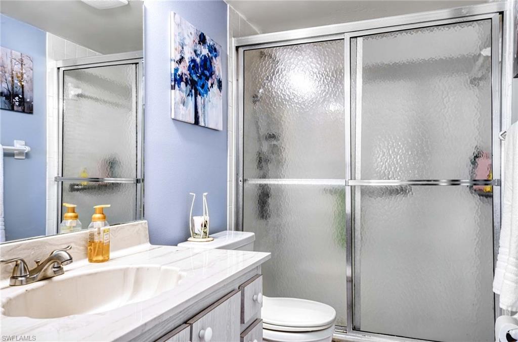 Full bath featuring vanity and a shower stall