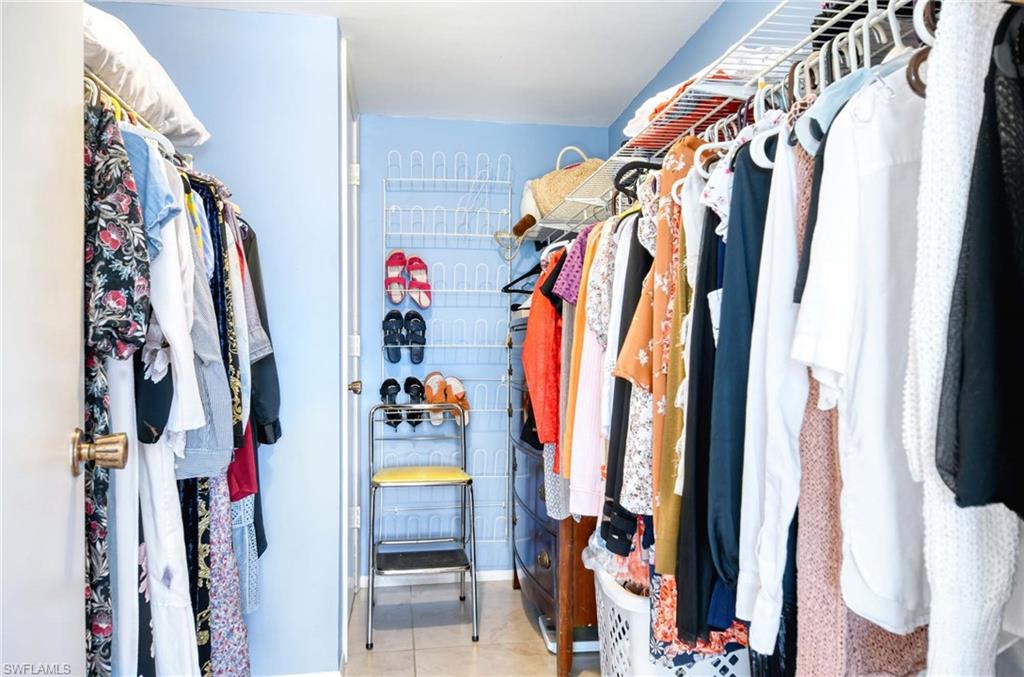 Walk in closet with light tile patterned floors