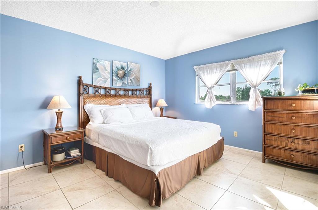 Bedroom featuring a textured ceiling and light tile patterned floors