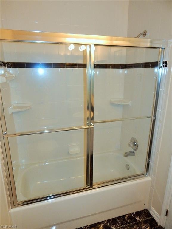 Bathroom featuring enclosed tub / shower combo