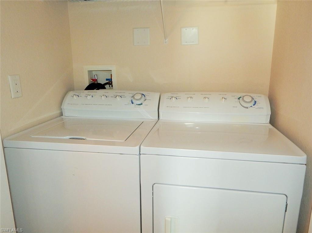 Washroom with washing machine and clothes dryer