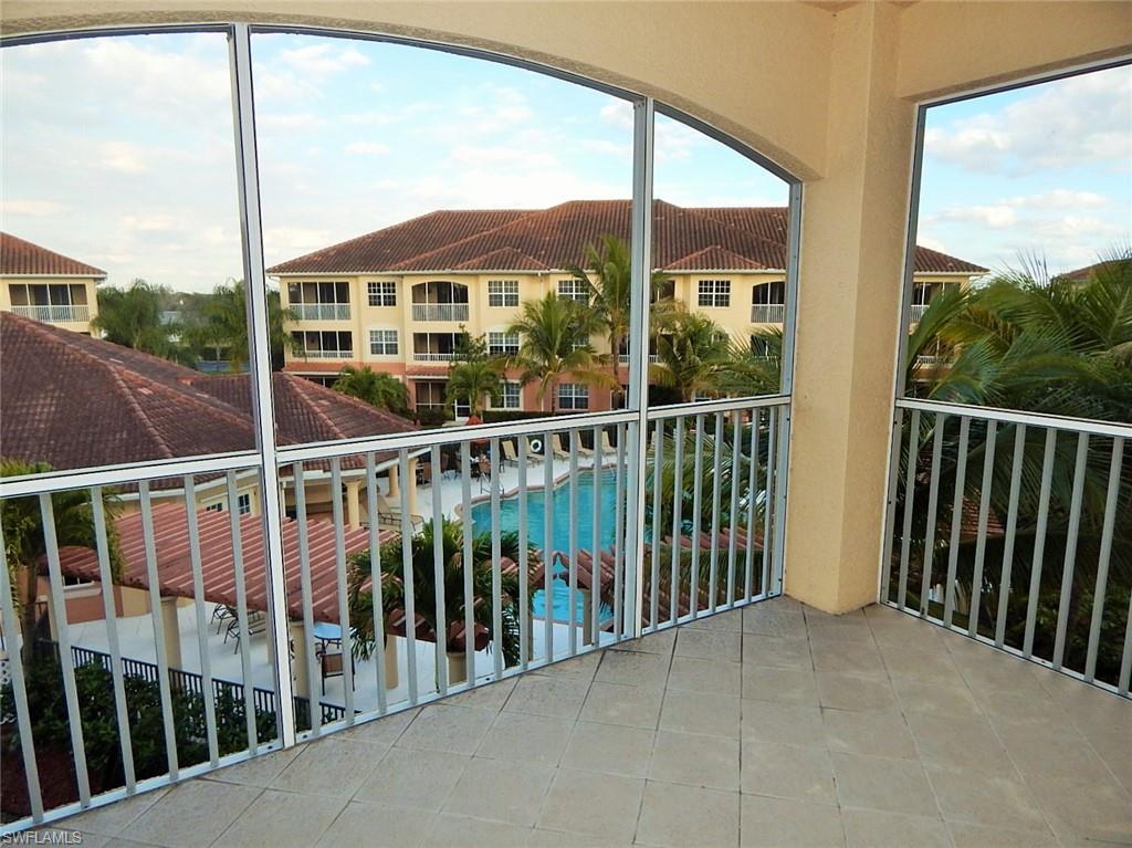 Balcony with view of pool and a sunroom