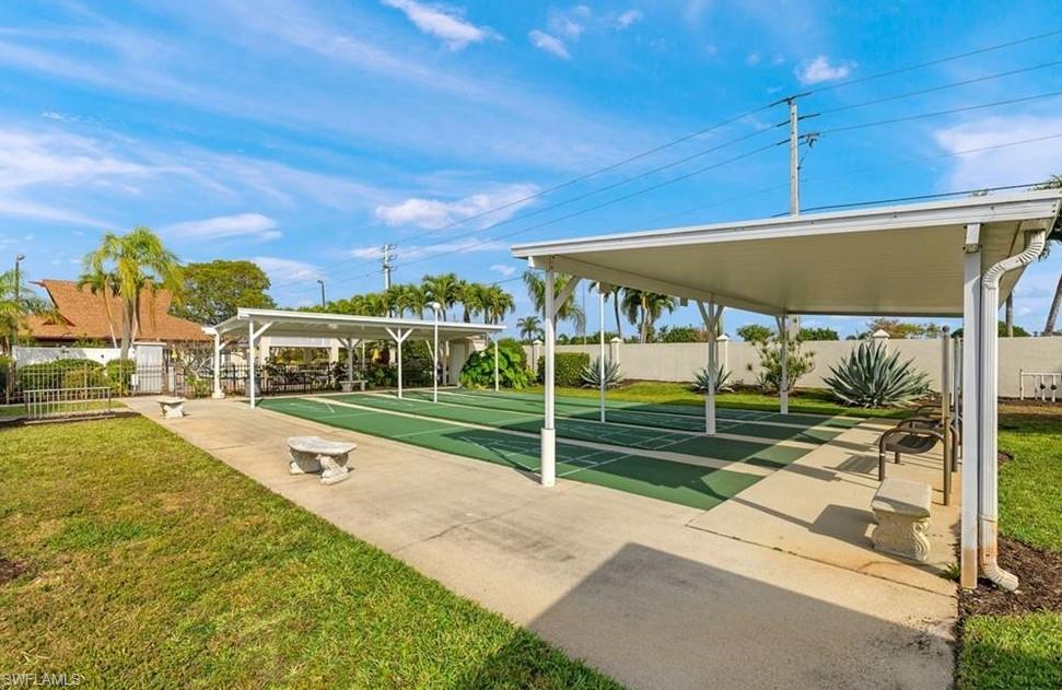 View of home's community featuring shuffleboard and a patio