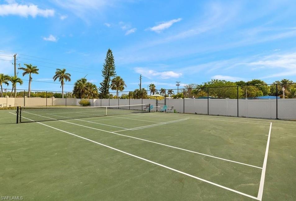 View of tennis court featuring community basketball court