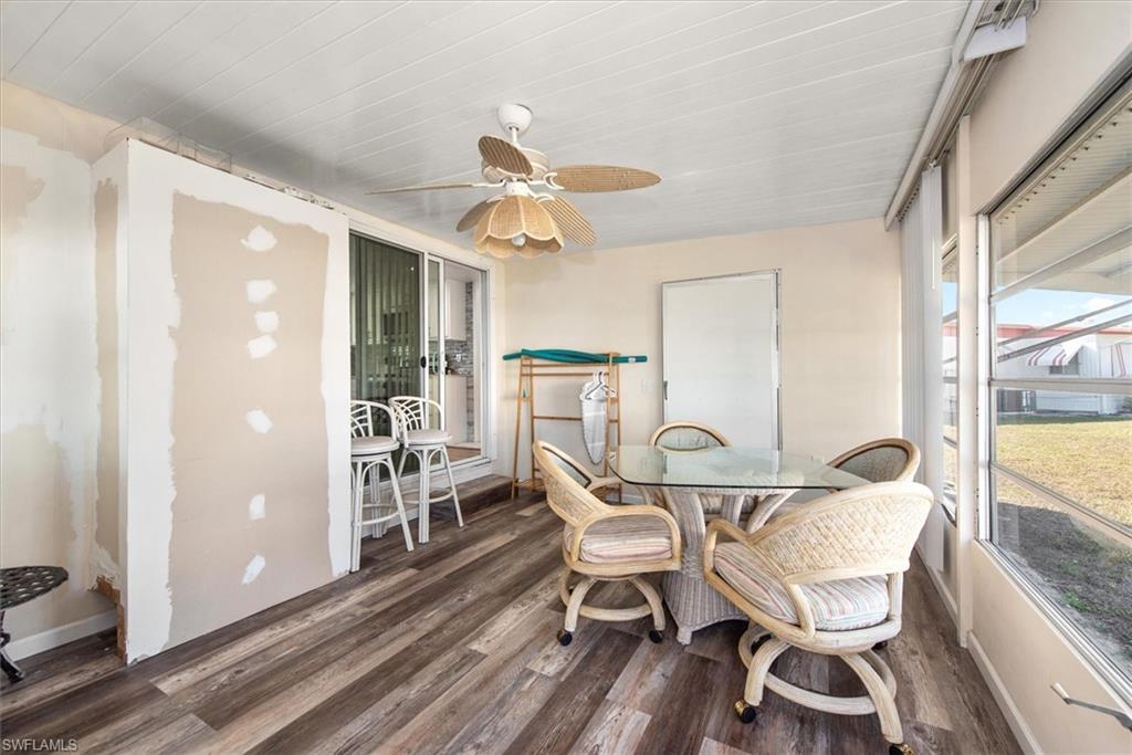Sunroom with ceiling fan and outdoor dining space