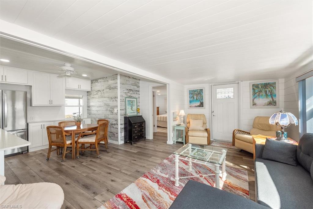 Living room with light wood finished floors and ceiling fan
