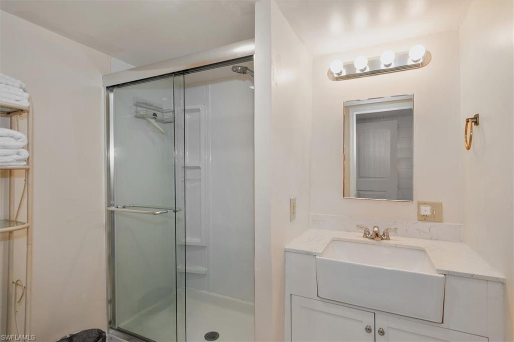 Full bath featuring vanity and a shower stall