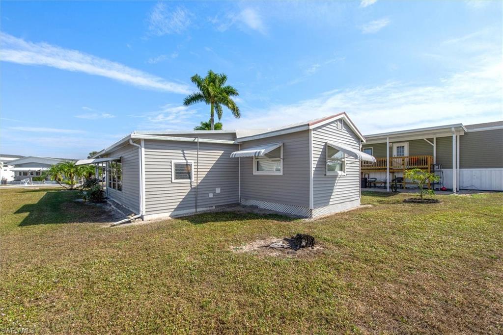 Rear view of property featuring a lawn