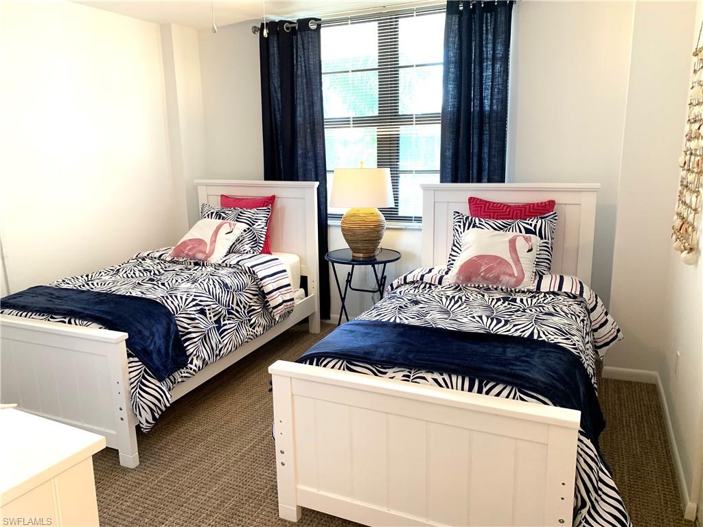 Bedroom with dark colored carpet