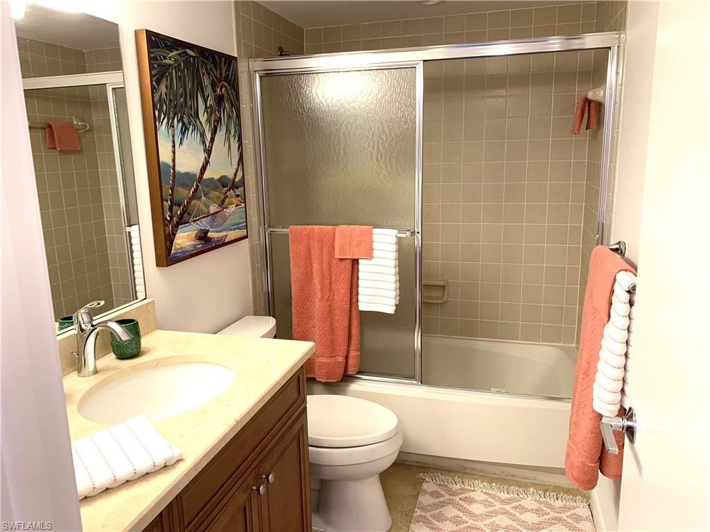 Full bathroom with vanity and combined bath / shower with glass door