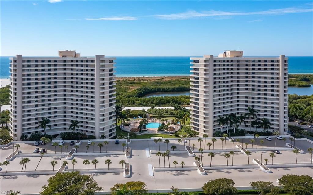 Aerial view of apartment complex and a large body of water