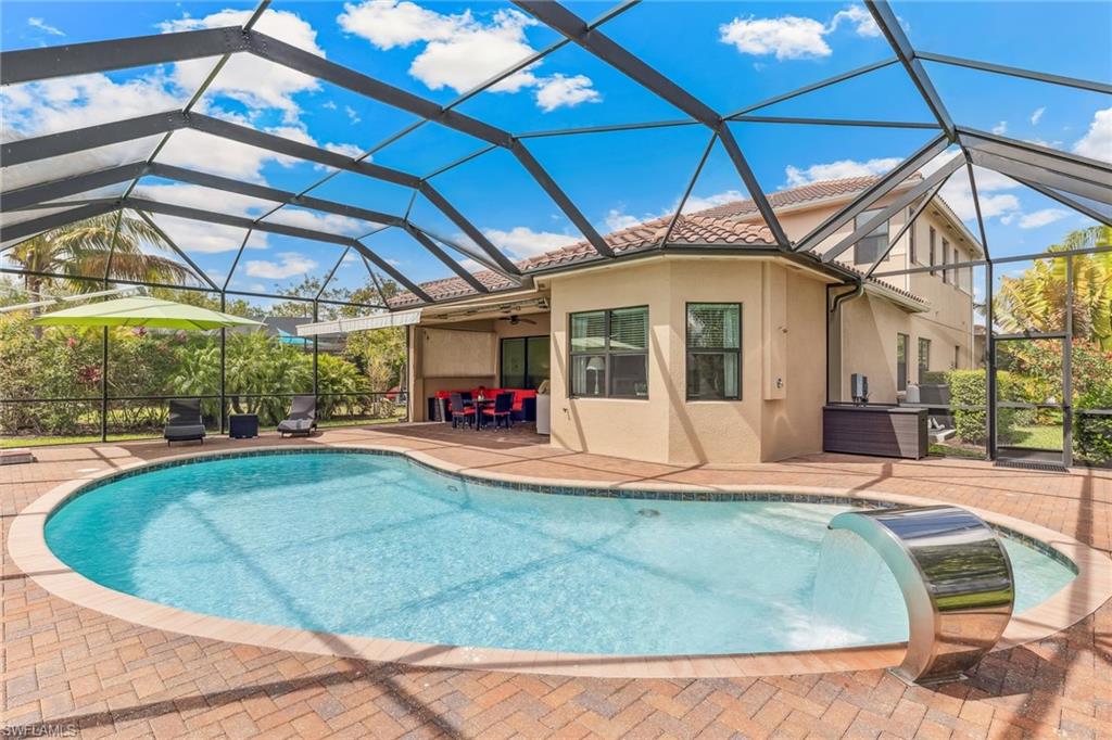 Pool with water feature, outdoor shower, over-sized side yard with mature mango and avocado tree.