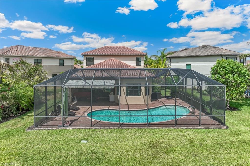 Spacious 4 bedroom/4 bath pool home in Naples, Florida located on an oversize corner pie shaped lot with lake view and privacy, large side yard with mature mango and avocado trees.