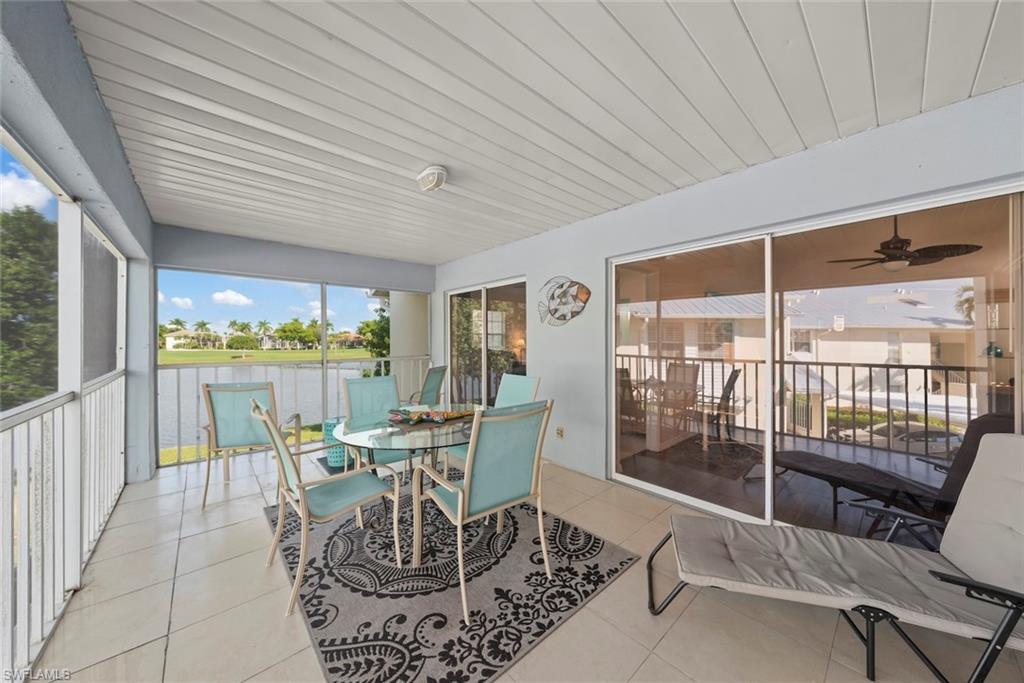 Huge lanai overlooks sparkling lake with golf course in the distance