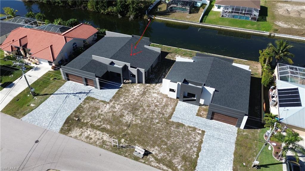Aerial perspective of suburban area with a large body of water