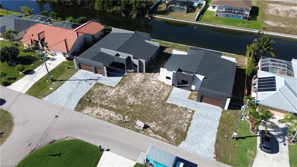 Aerial view of residential area with a nearby body of water. Unit is on the left side!