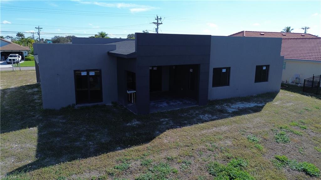 Rear view of property with a patio and stucco siding