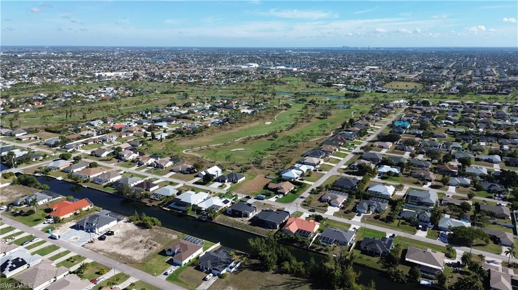 Aerial overview of property's location featuring nearby suburban area and a large body of water