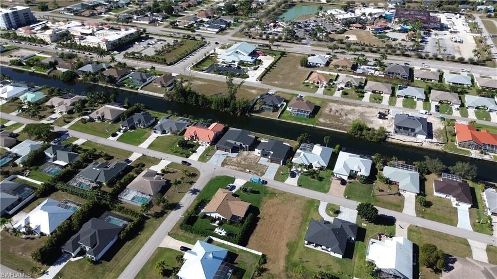 Aerial overview of property's location with nearby suburban area and a nearby body of water