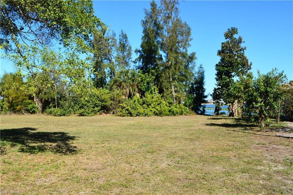 View of grassy yard with a water view