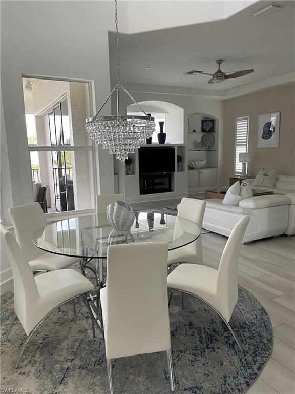 Dining room with ceiling fan and a chandelier