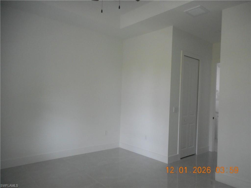 Unfurnished room with baseboards and ceiling fan