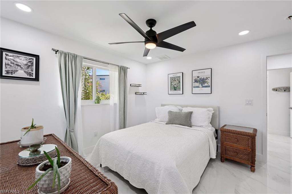 Bedroom with recessed lighting, ceiling fan, and marble finish floors