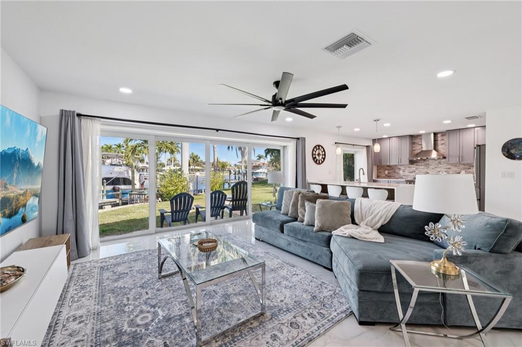 Living room featuring recessed lighting and a ceiling fan