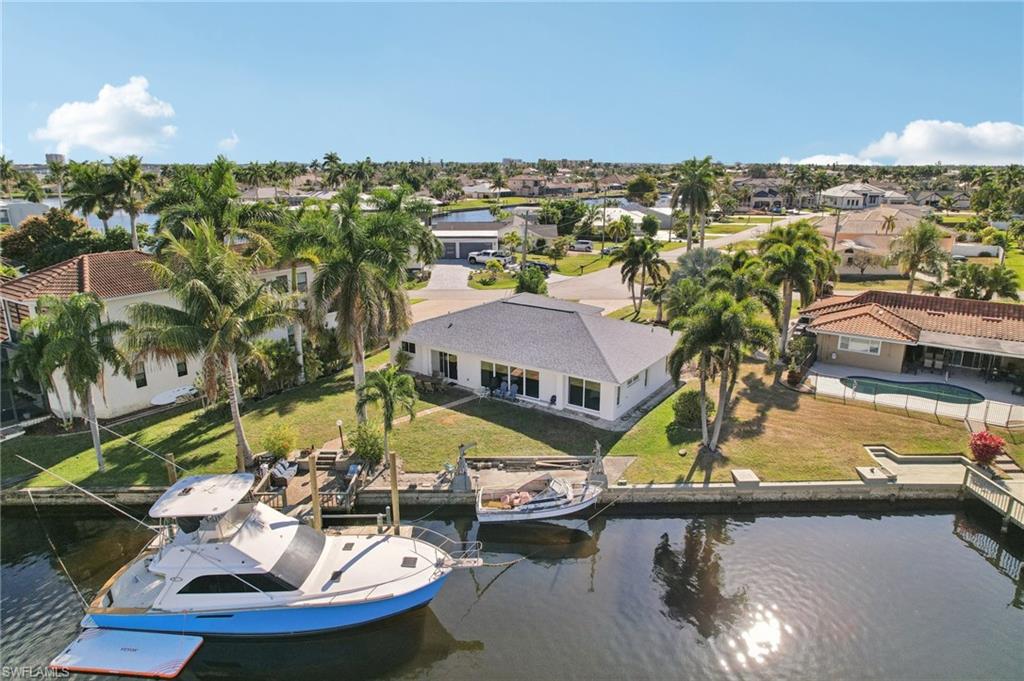 Aerial perspective of suburban area featuring a large body of water