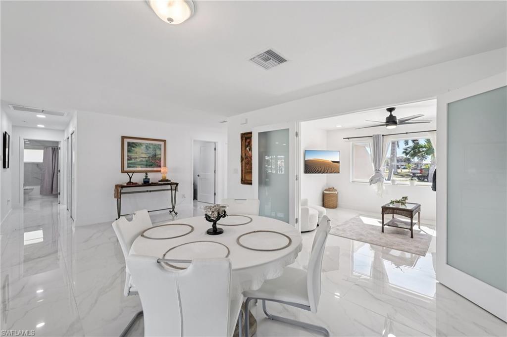 Dining room with light marble finish flooring and a ceiling fan