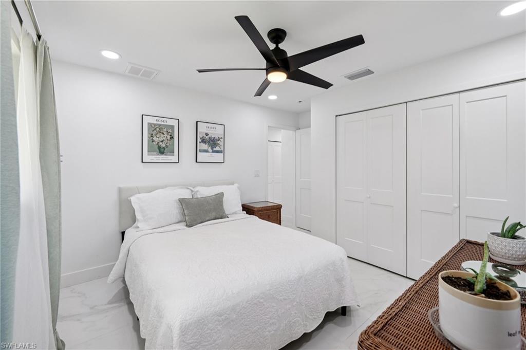 Bedroom with marble finish floors, recessed lighting, a closet, and ceiling fan
