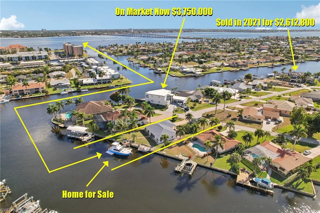 Aerial perspective of suburban area with a nearby body of water and property boundaries highlighted