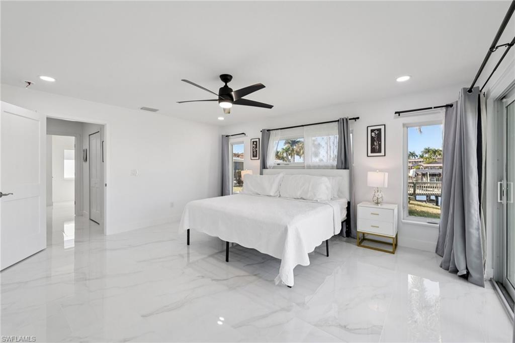 Bedroom with recessed lighting, a ceiling fan, and light marble finish floors