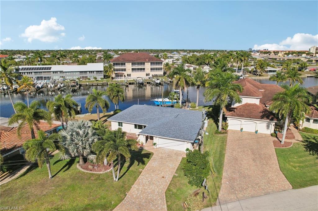 Aerial perspective of suburban area featuring a large body of water