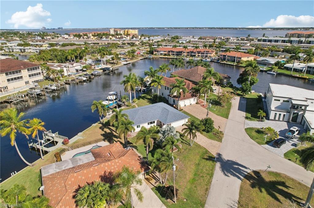 Aerial view of property's location with a large body of water and nearby suburban area