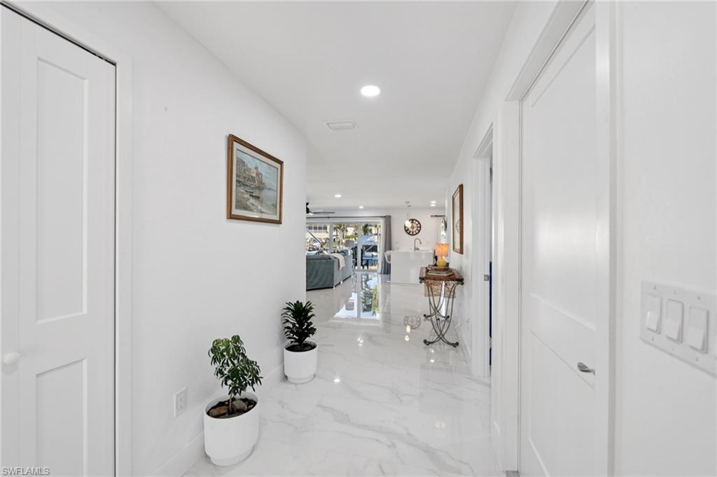 Hallway featuring recessed lighting and marble tiled floors
